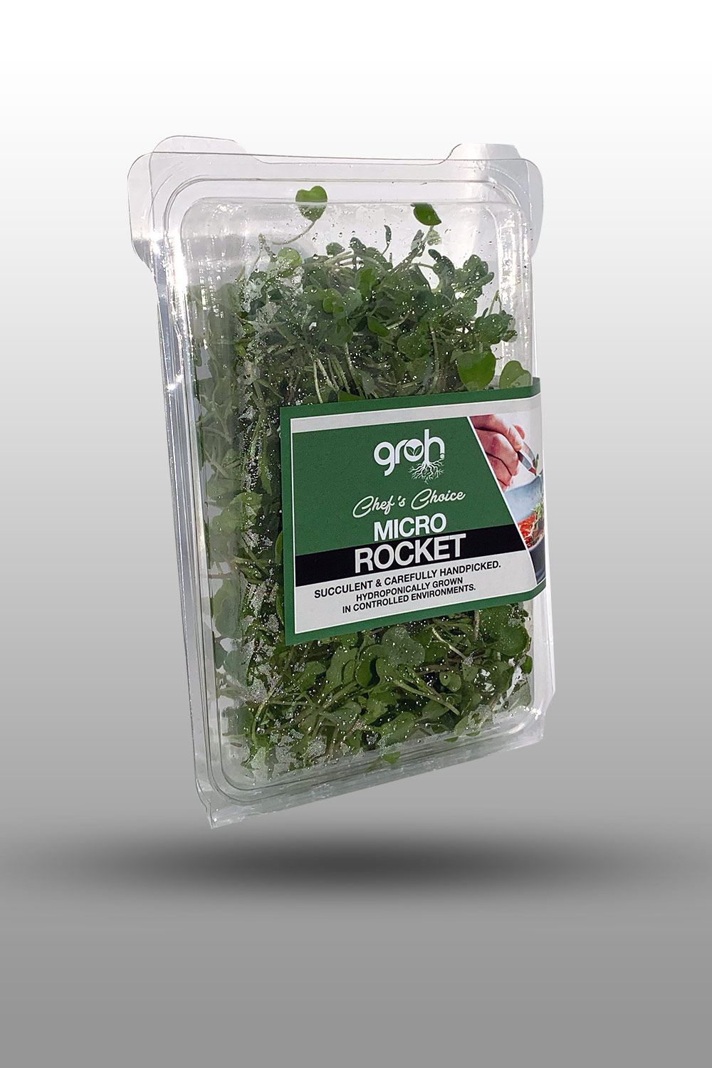 Chef in hotel or restaurant kitchen cooking, only hands. He is working on the micro herb decoration. Preparing tomato soup.